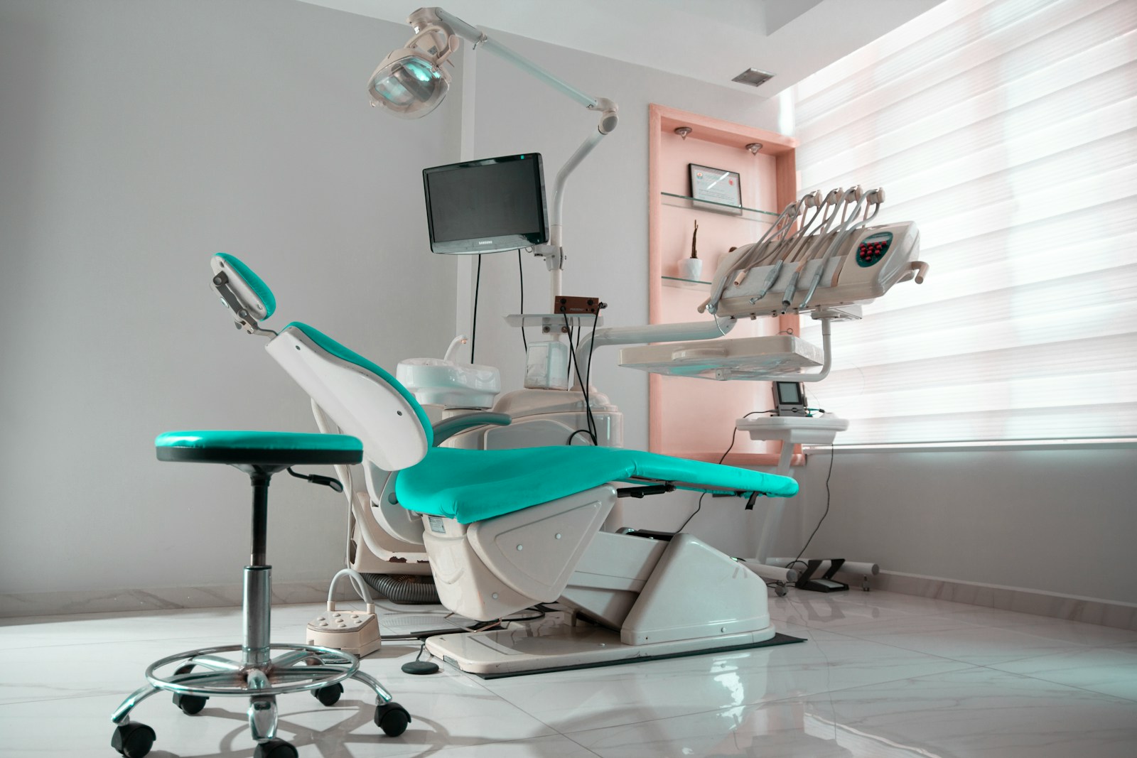 a dental room with a chair and a monitor